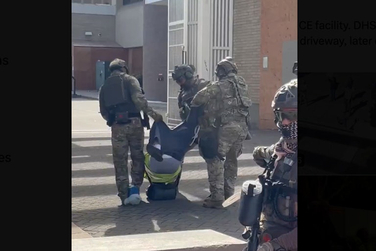 Three federal agents drag a man by his pants as his head hits the pavement.