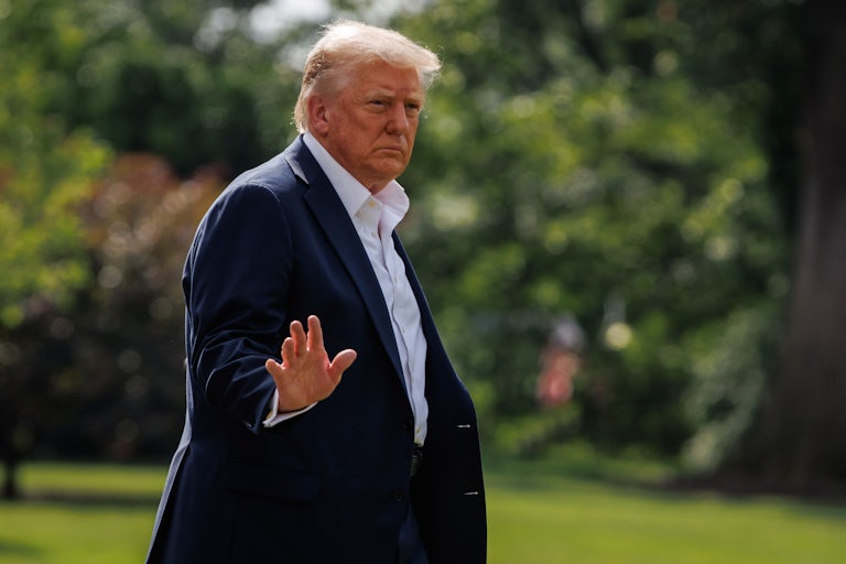 Donald Trump waves as he walks on the lawn of the White House.