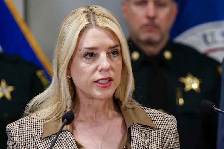 Attorney General Pam Bondi speaks into a microphone