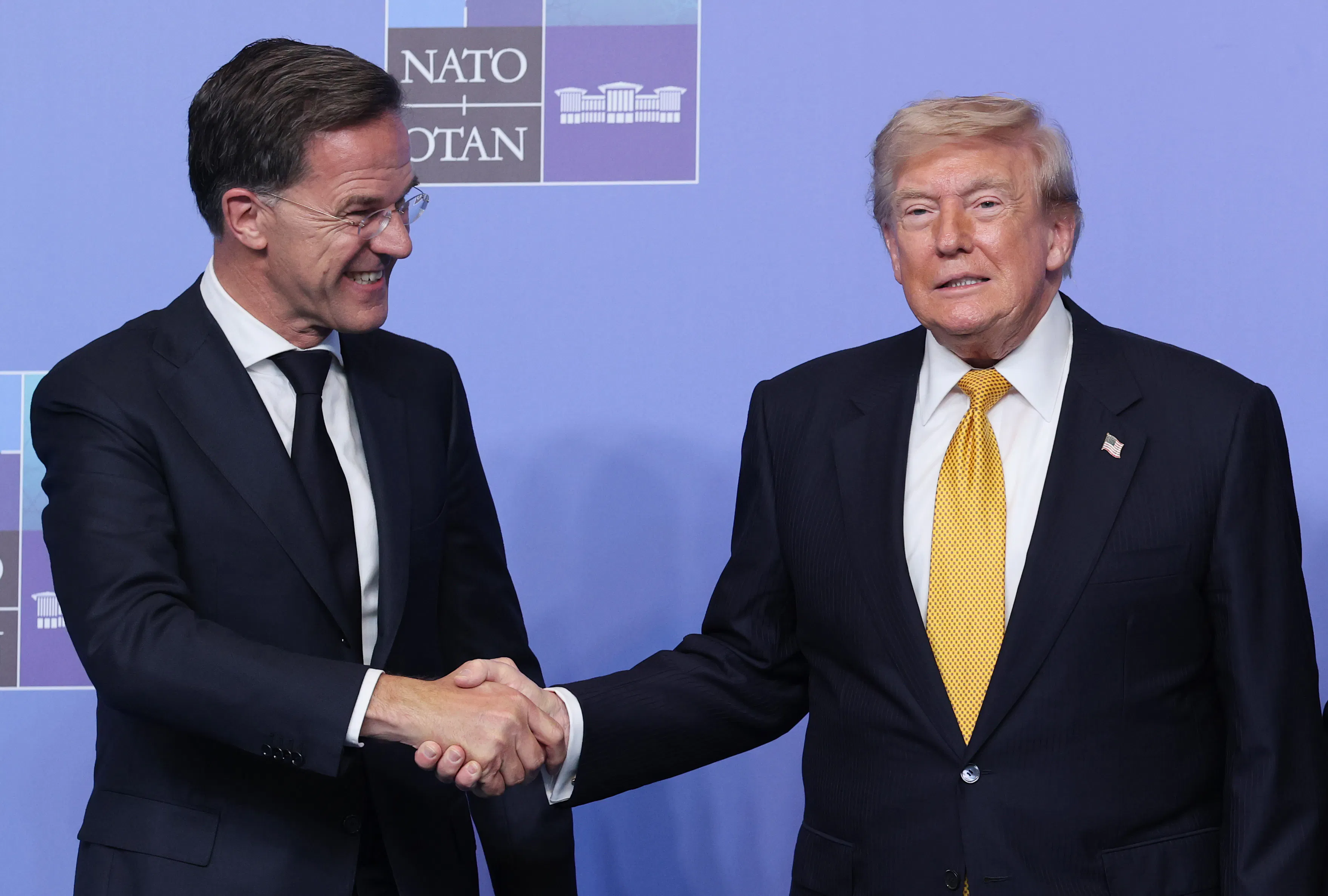 Donald Trump and Mark Rutte shake hands, both smiling