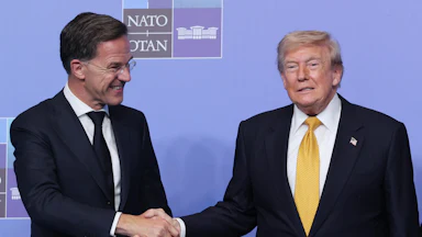 Donald Trump and Mark Rutte shake hands, both smiling