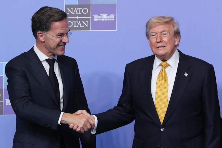 Donald Trump and Mark Rutte shake hands, both smiling