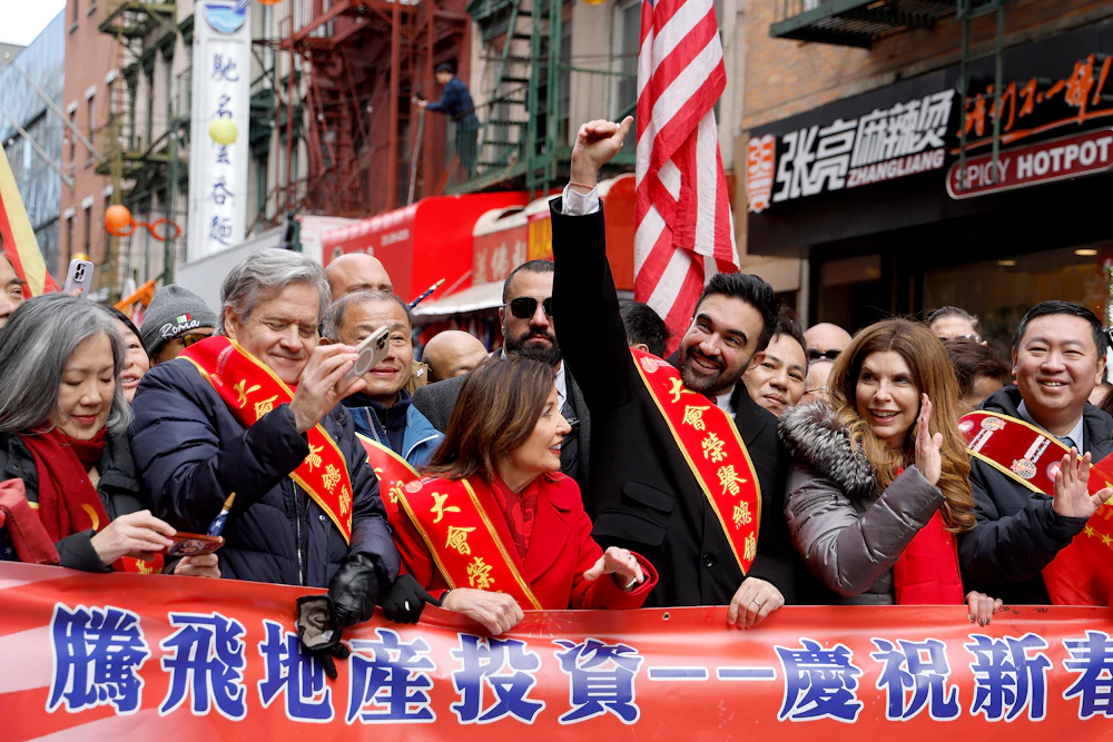Zohran Mamdani at a Lunar New Year parade with Gov. Kathy Hochul (left) and City Council Speaker Julie Menin (right)