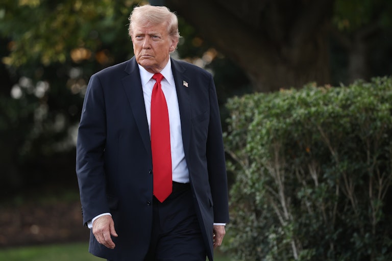 President Donald Trump walks toward reporters.