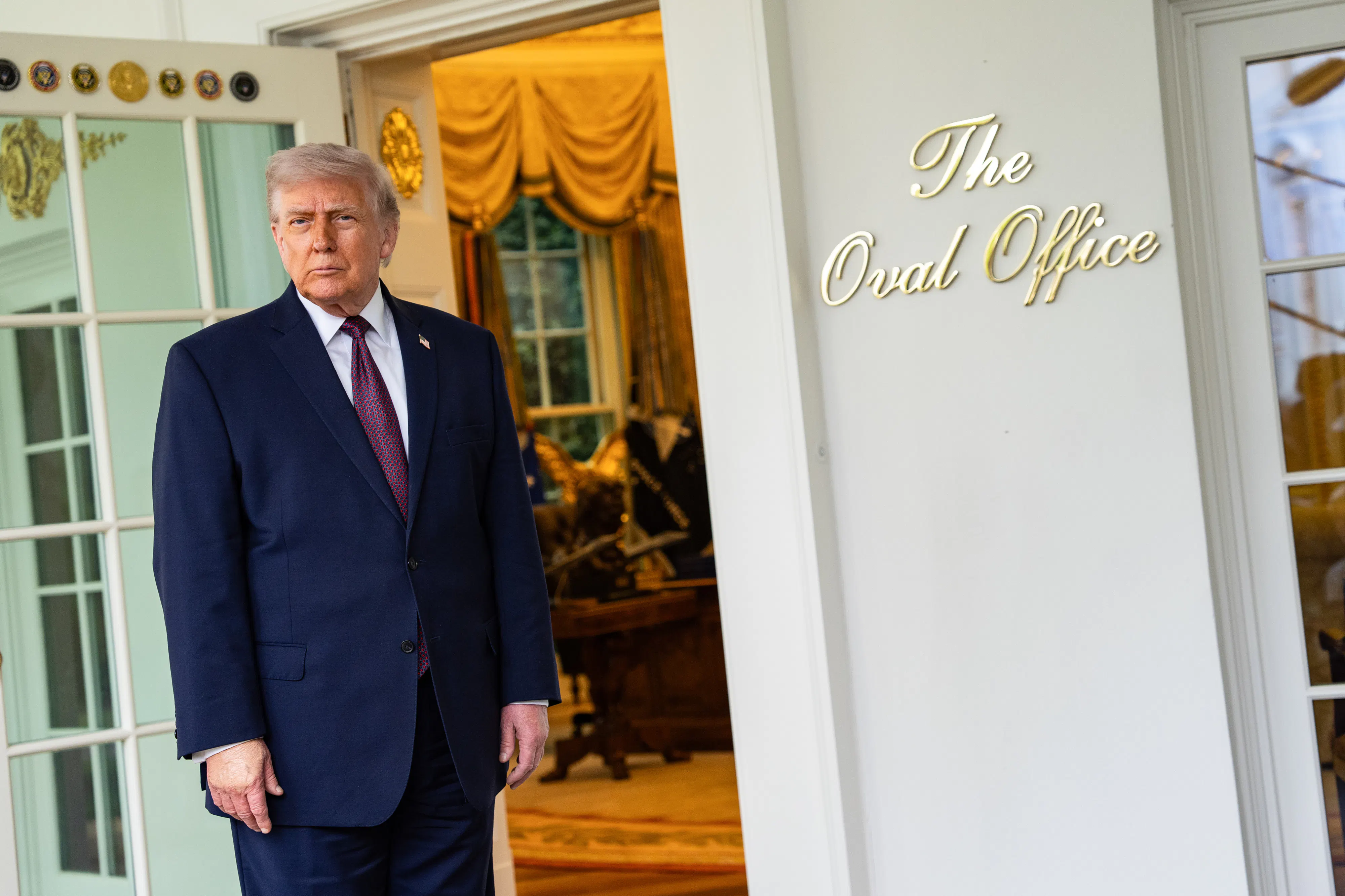 Donald Trump speaks to members of the media outside the Oval Office.