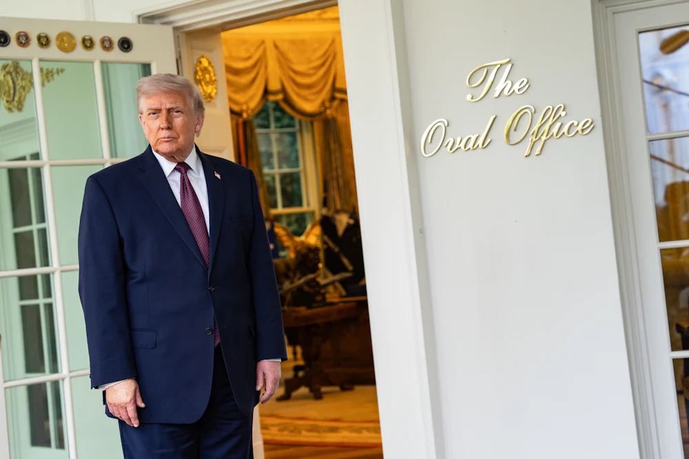 Donald Trump speaks to members of the media outside the Oval Office.