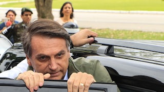Jair Bolsonaro gets into a car.
