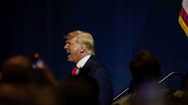 Donald Trump, on stage in North Carolina, shouts into the distance