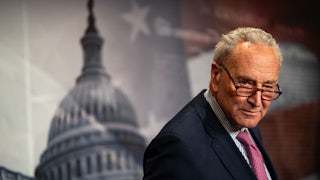 Chuck Schumer looks over his glasses