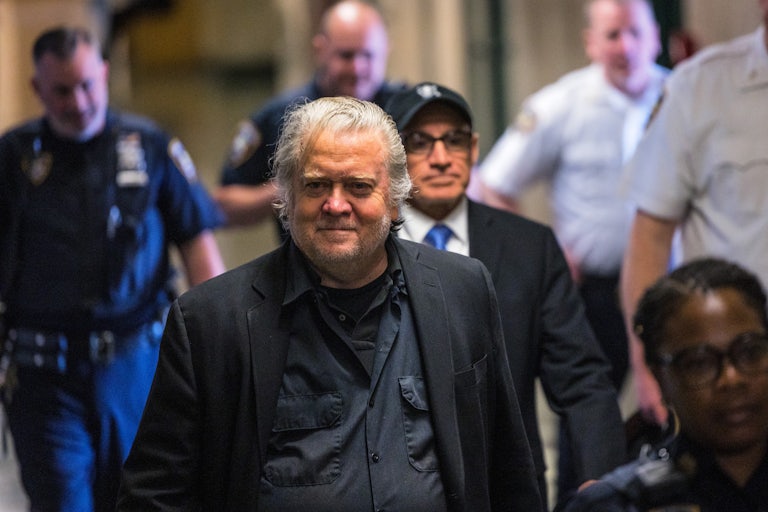 Steve Bannon smiles while walking in court