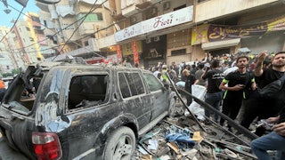 People in Beirut gather near rubble after an Israeli strike on November 23, 2025.