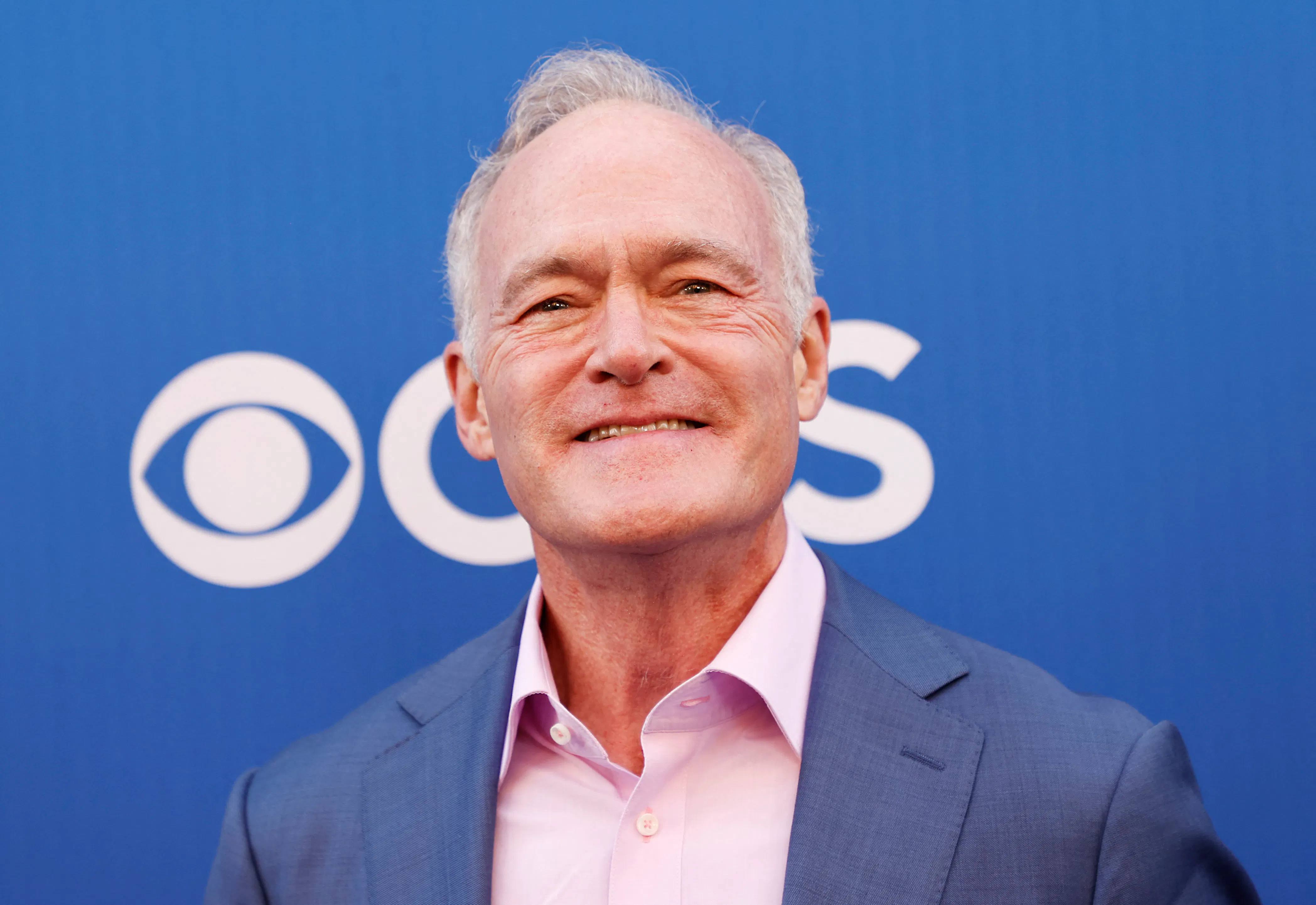 Scott Pelley smiles at an event
