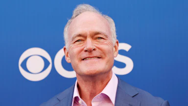 Scott Pelley smiles at an event