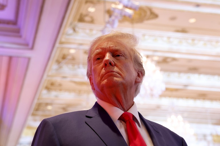 Donald Trump looks imperious standing beneath a regal ceiling.