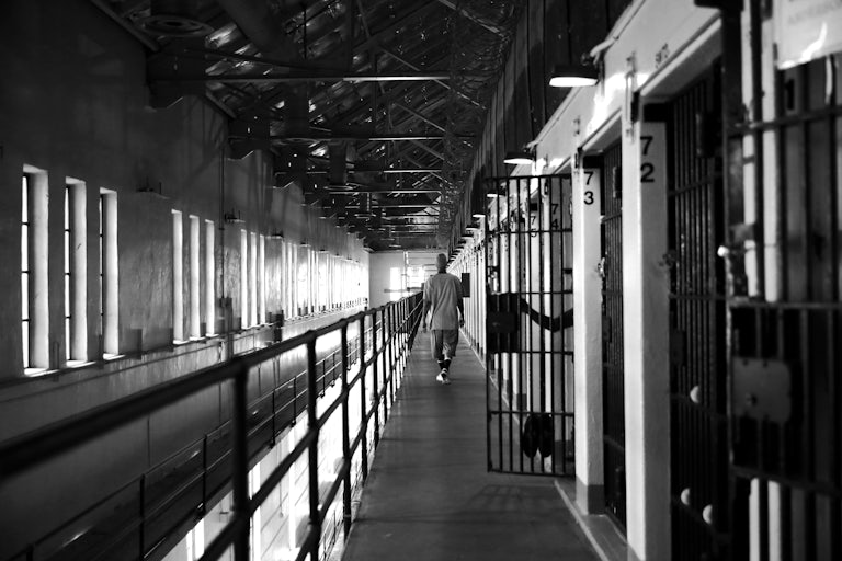 A man walks down the hallway near his cell at San Quentin Prison in California.