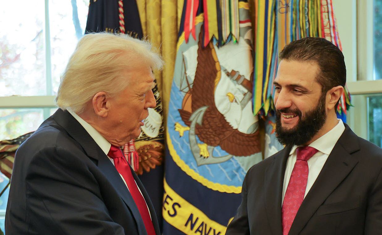 Donald Trump speaks to Syrian President Ahmed al-Sharaa at the White House.