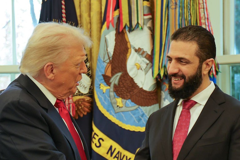 Donald Trump speaks to Syrian President Ahmed al-Sharaa at the White House.