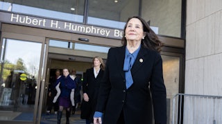 Diana DeGette walks out of the Hubert H. Humphrey Building, followed by others.