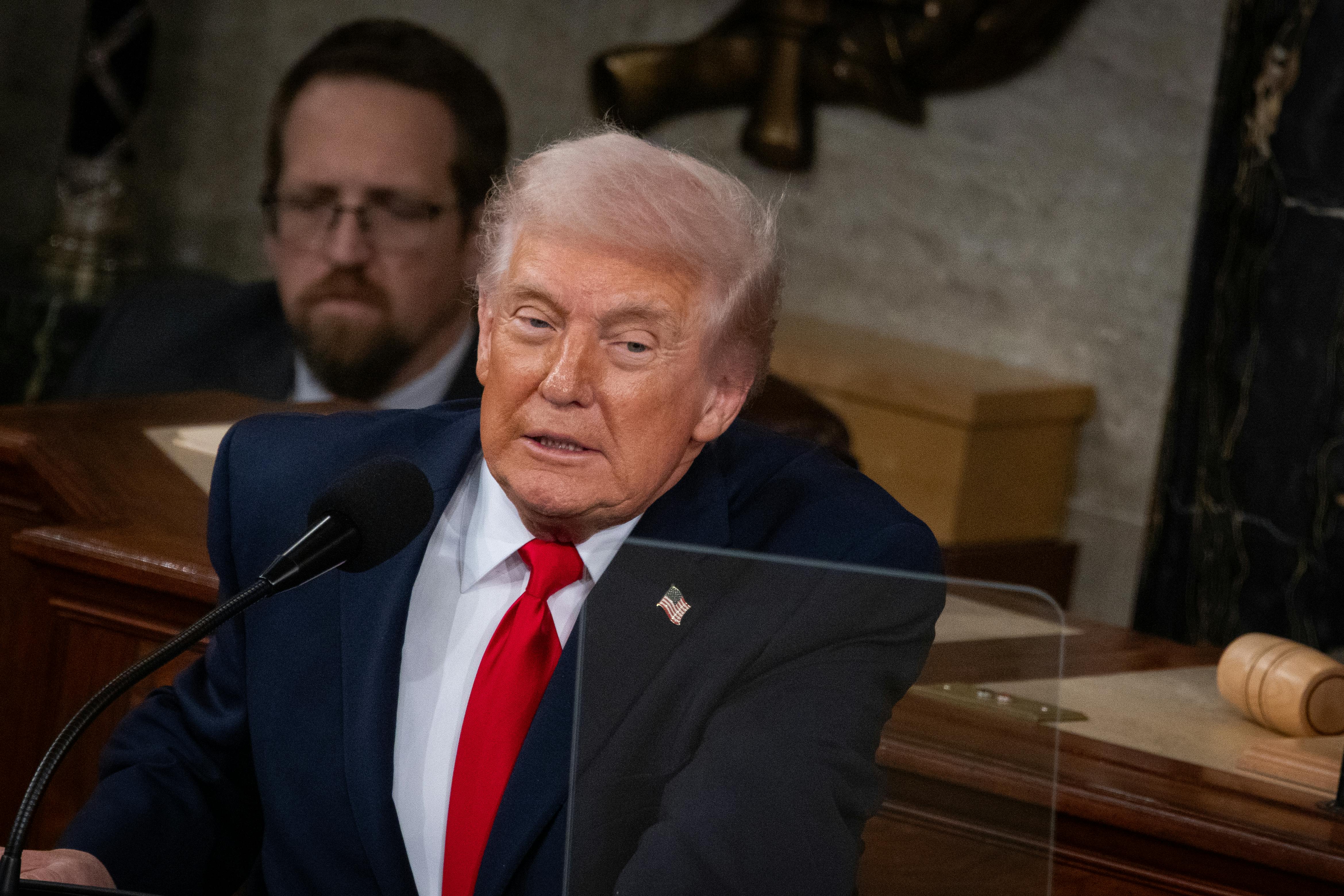 Donald Trump leans forward while delivering the State of the Union
