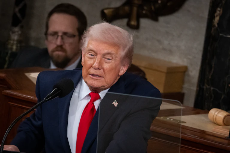 Donald Trump leans forward while delivering the State of the Union