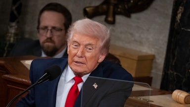 Donald Trump leans forward while delivering the State of the Union