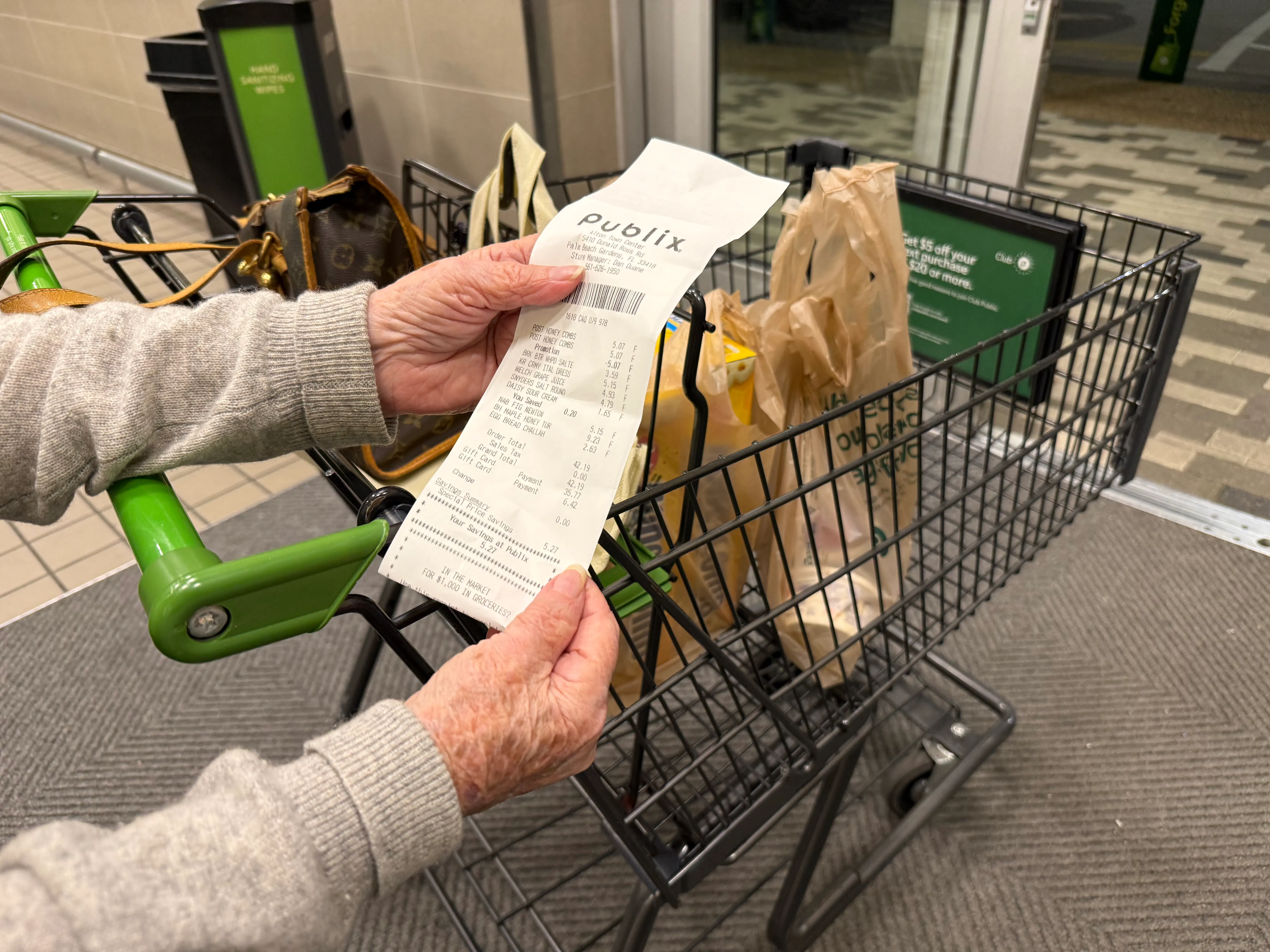 Mature woman reviewing receipt after shopping at Publix supermarket, Florida. 