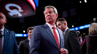 Georgia Governor Brian Kemp looks over his shoulder