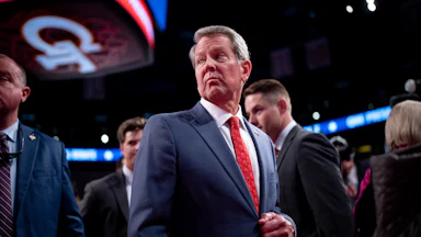 Georgia Governor Brian Kemp looks over his shoulder