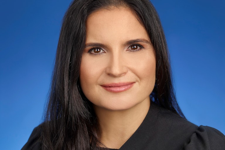 Judge Aileen Cannon headshot (looks like a yearbook photo, blue background)
