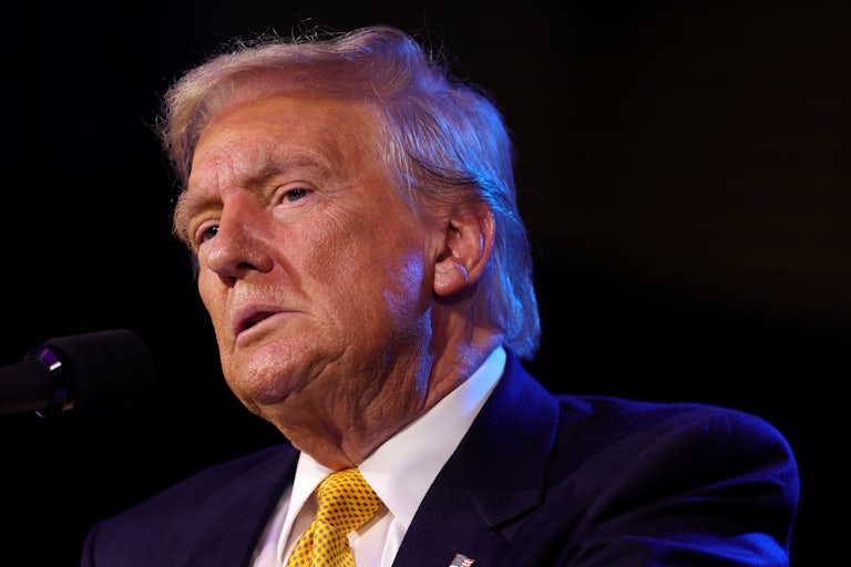 Donald Trump stands in front of a microphone