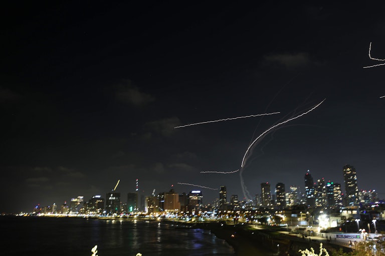 Iranian bombs and interceptors being fired over Israel