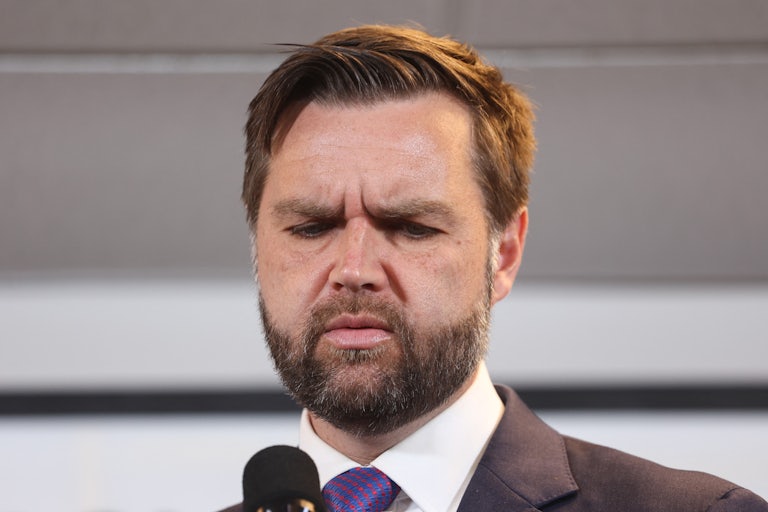 J.D. Vance looks down during a Donald Trump campaign event