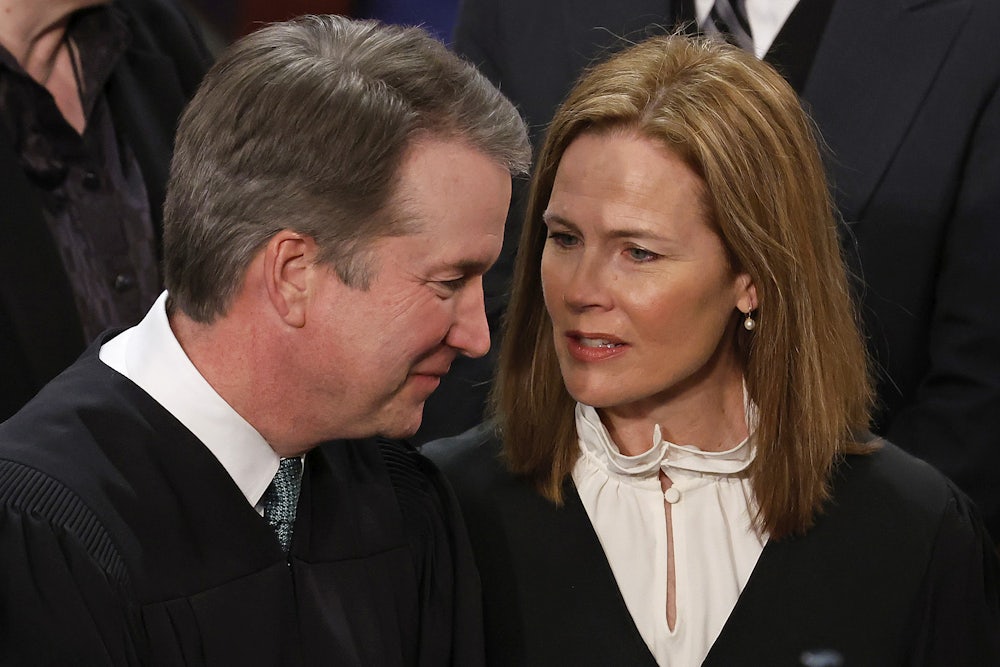 WASHINGTON, DC - FEBRUARY 07: U.S. Supreme Court Associate Justices Brett Kavanaugh (L) and Amy Coney Barrett talk before President Joe Biden delivers the State of the Union address to a joint session of Congress in the House Chamber at the U.S. Capitol in Washington, D.C.