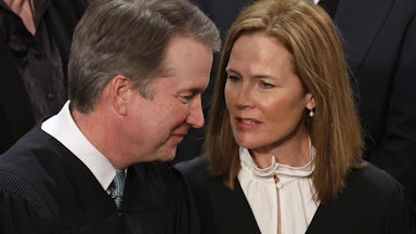 WASHINGTON, DC - FEBRUARY 07: U.S. Supreme Court Associate Justices Brett Kavanaugh (L) and Amy Coney Barrett talk before President Joe Biden delivers the State of the Union address to a joint session of Congress in the House Chamber at the U.S. Capitol in Washington, D.C.