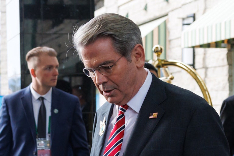 Treasury Secretary Scott Bessent looks down while walking at the G7 meeting