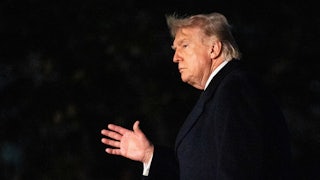 Donald Trump waves while walking outside the White House