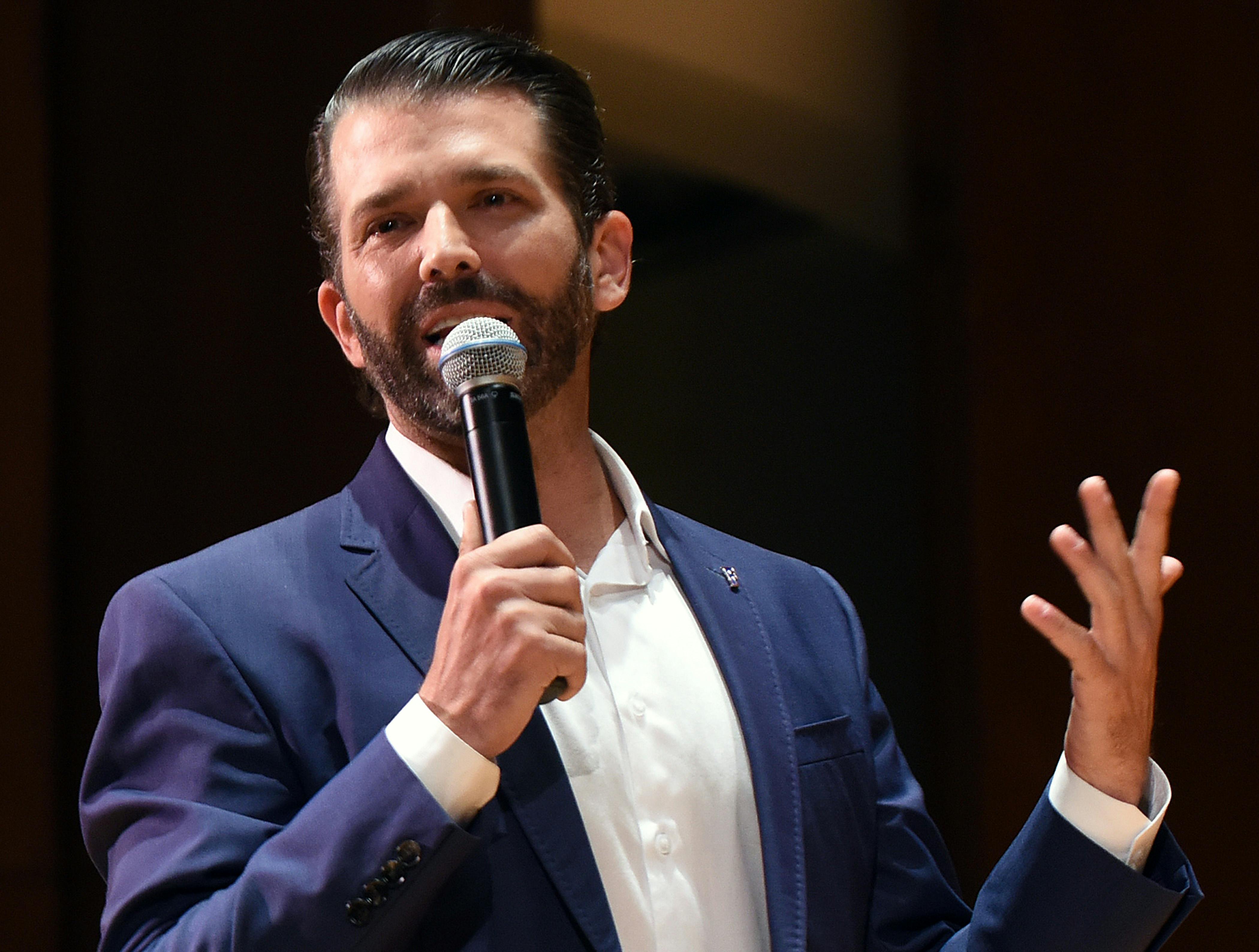 Donald Trump Jr. speaks into a handheld mic