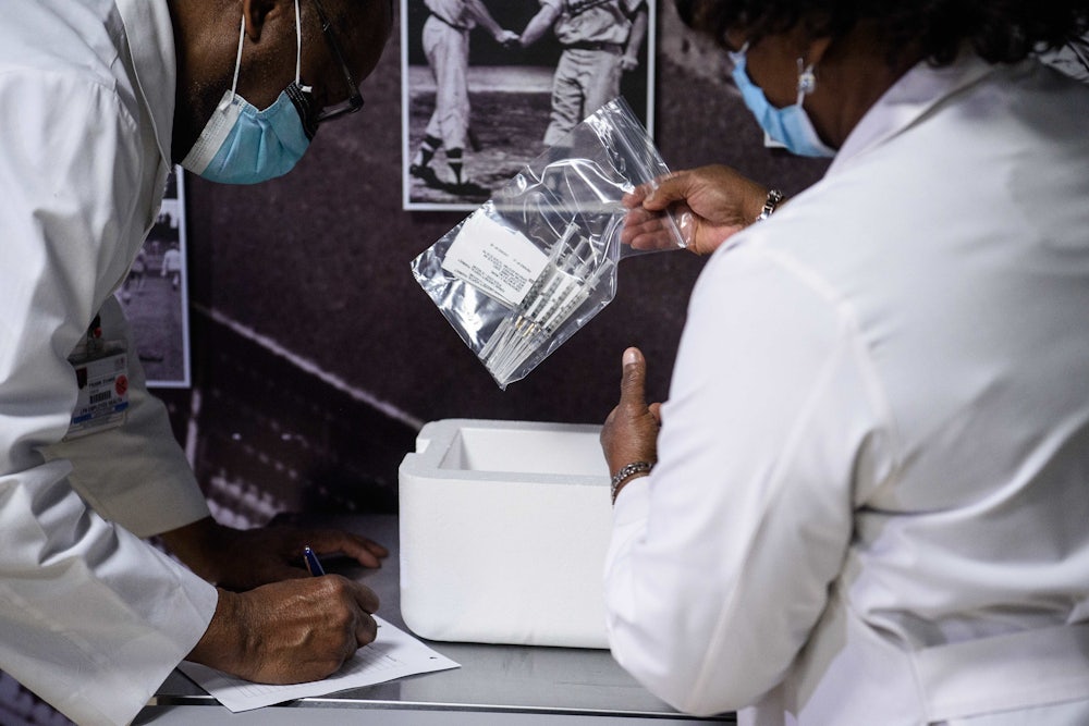 Nurses at Howard University Hospital in Washington, D.C., check syringes pre-filled with the Covid-19 vaccine.