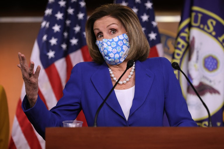 A masked Nancy Pelosi speaks at a news conference on Capitol Hill.