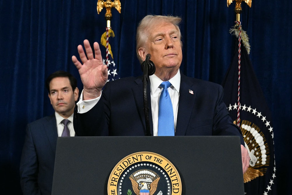 Donald Trump speaks to the press as Secretary of State Marco Rubio looks on following US military actions in Venezuela.