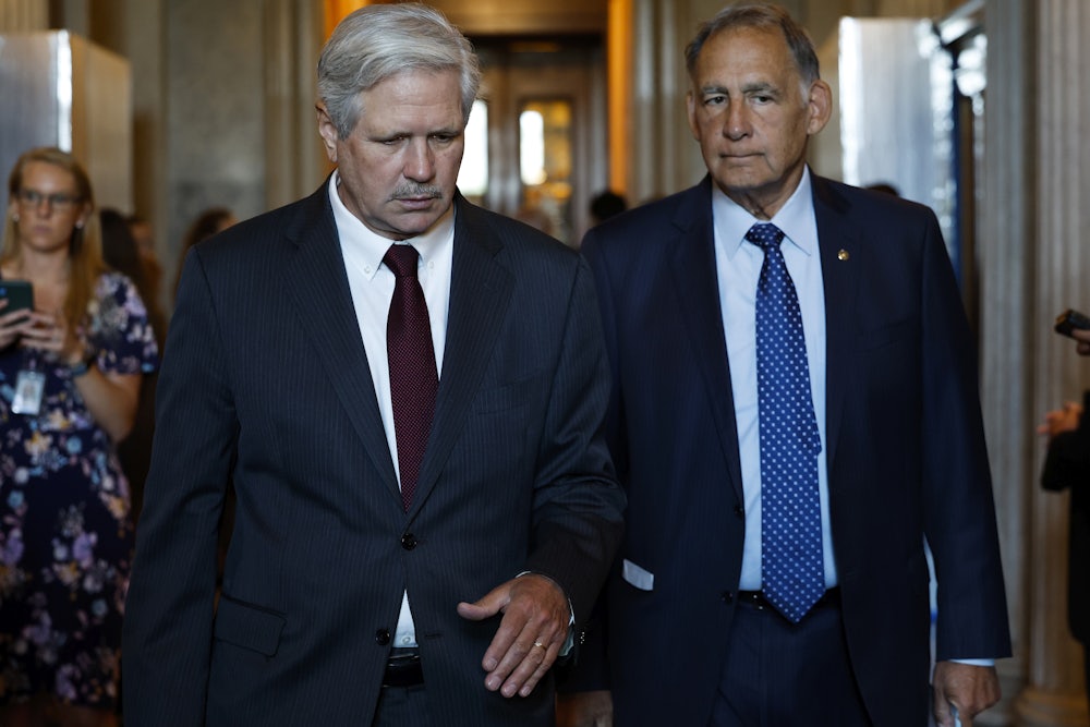 Senators John Hoeven (left) and John Boozman walking through the Capitol