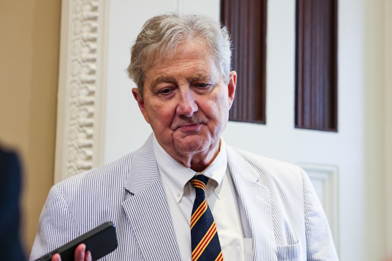 Senator John Kennedy looks down while speaking to reporters in the Capitol
