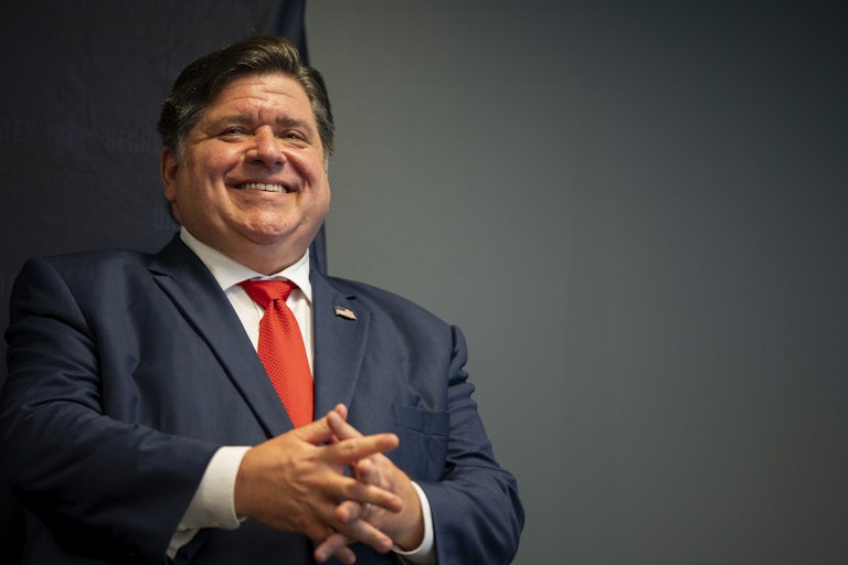 Illinois Governor J.B. Pritzker smiles during a 2024 United States Democratic National Convention security briefing.
