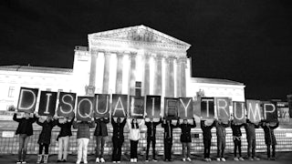 MoveOn members hold signs that read "Disqualify Trump" during a rally outside of the U.S. Supreme Court of the United States on February 01, 2024 in Washington, DC.