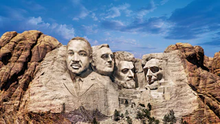 A digitally altered photograph of Mount Rushmore depicting four faces carved into the mountain in place of the original presidents. From left to right: a figure resembling Martin Luther King, FDR, Frederick Douglass, and Lincoln.