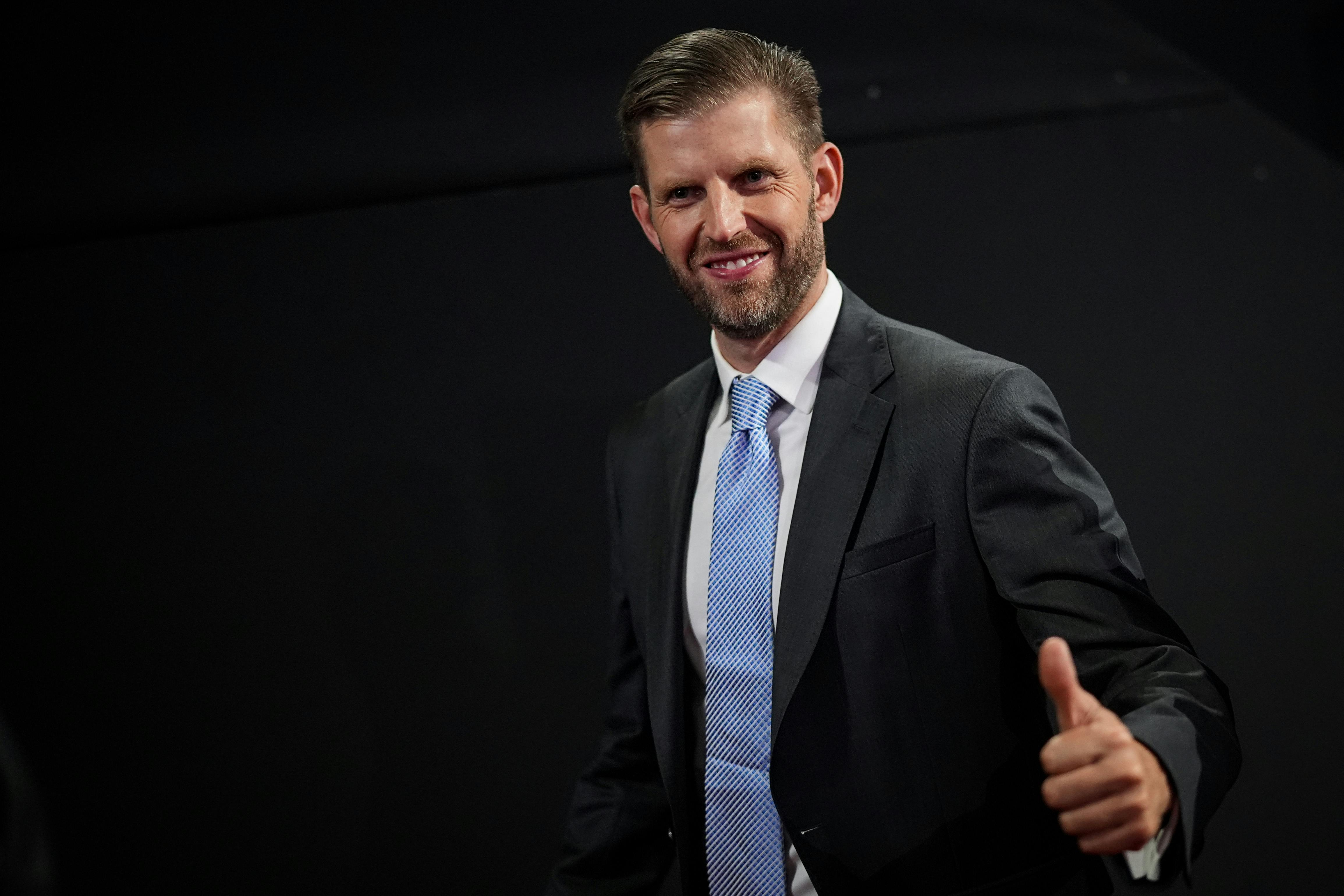 Eric Trump smiles and gives a thumbs up