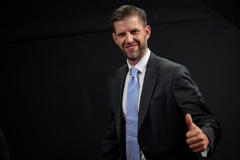Eric Trump smiles and gives a thumbs up