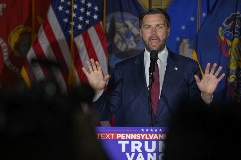 J.D. Vance speaks and holds his hands up as if in outrage or defense