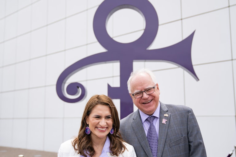 Minnesota Lieutenant Governor Peggy Flanagan and Governor Tim Walz stand in front of a stretch of highway renamed after Prince
