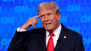 Donald Trump points to his own head